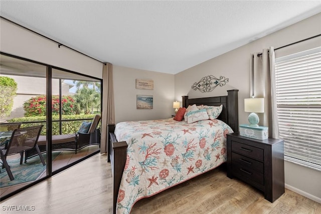 9623 Eaton Gardens Ln Unit 105, Fort Myers, FL 33919 - bedroom featuring access to exterior and light wood-style flooring