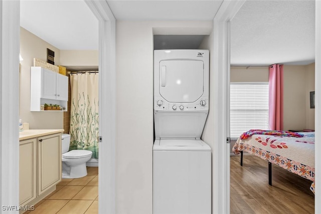 9623 Eaton Gardens Ln Unit 105, Fort Myers, FL 33919 - laundry room featuring stacked washer / dryer, laundry area, and light tile patterned floors