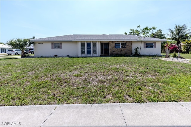 4646 Palm Tree Blvd, Cape Coral, FL 33904 - ranch-style house with a front yard and stucco siding
