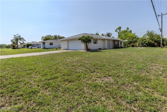 4646 Palm Tree Blvd, Cape Coral, FL 33904 - view of front facade with driveway, a garage, and a front yard