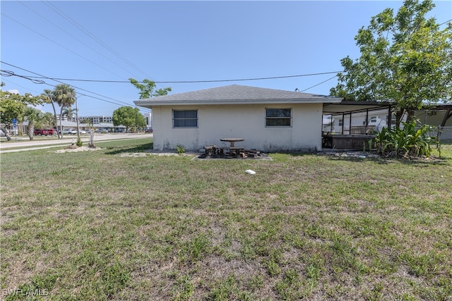 4646 Palm Tree Blvd, Cape Coral, FL 33904 - rear view of house with a yard, stucco siding, and a sunroom