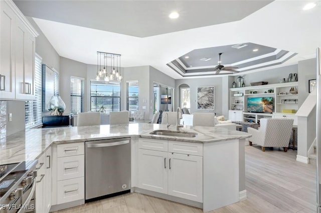 kitchen featuring stainless steel appliances, a sink, plenty of natural light, a chandelier, and recessed lighting