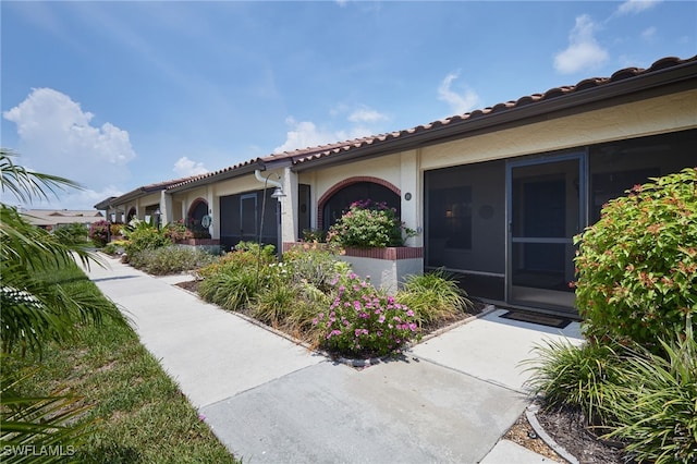 16860 Ginger Ln Unit 3049, Fort Myers, FL 33908 - view of side of property with a tile roof and stucco siding