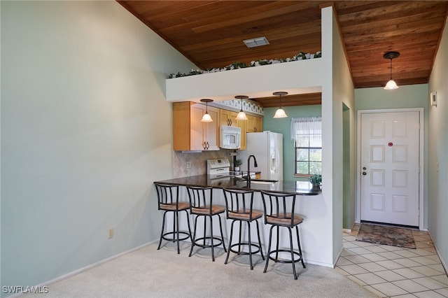 16860 Ginger Ln Unit 3049, Fort Myers, FL 33908 - kitchen with white appliances, wood ceiling, a kitchen breakfast bar, baseboards, and a peninsula