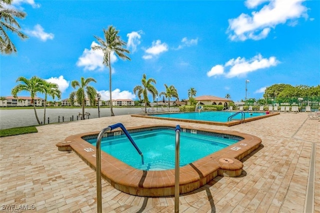 16860 Ginger Ln Unit 3049, Fort Myers, FL 33908 - community pool featuring a hot tub and a patio
