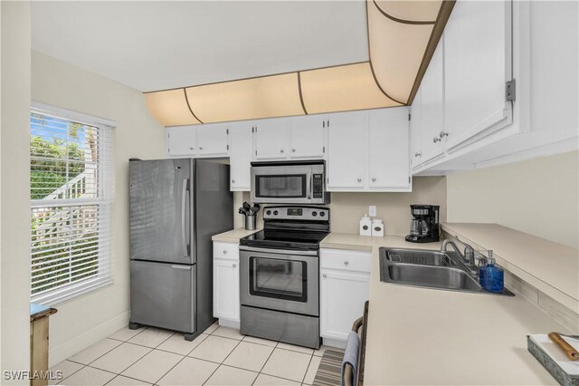 661 W Elkcam Cir Unit 911, Marco Island, FL 34145 - kitchen with appliances with stainless steel finishes, a sink, white cabinetry, and light tile patterned floors