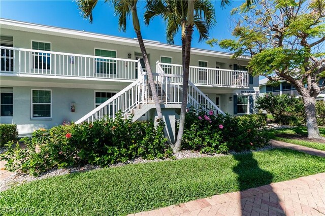 661 W Elkcam Cir Unit 911, Marco Island, FL 34145 - view of building exterior with stairway