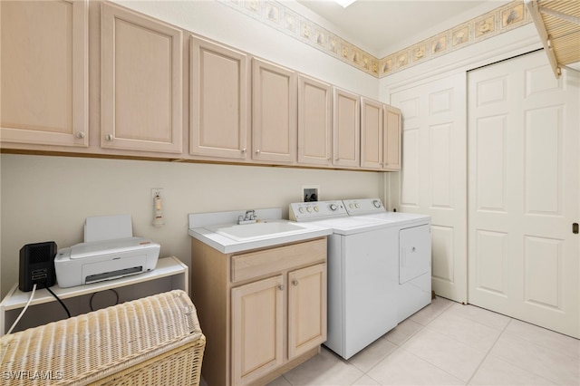 clothes washing area with washing machine and clothes dryer, cabinet space, a sink, and light tile patterned floors