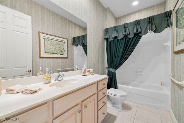 bathroom with toilet, vanity, tile patterned floors, and wallpapered walls