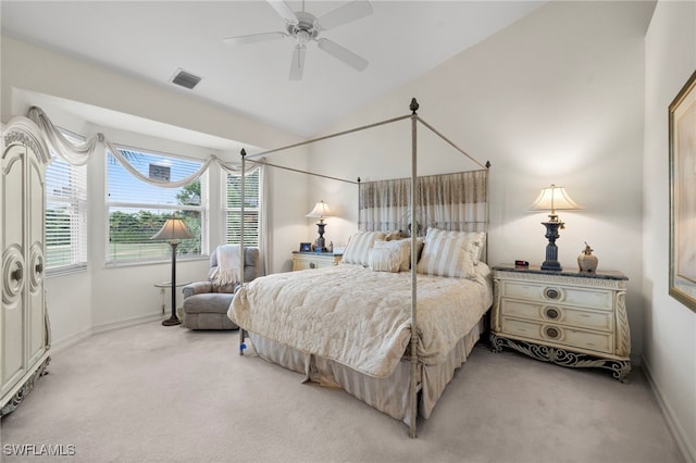 carpeted bedroom with lofted ceiling, baseboards, a ceiling fan, and visible vents