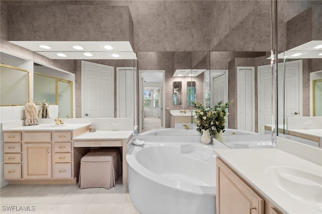 full bathroom featuring tile patterned flooring, a sink, a bath, a closet, and a stall shower