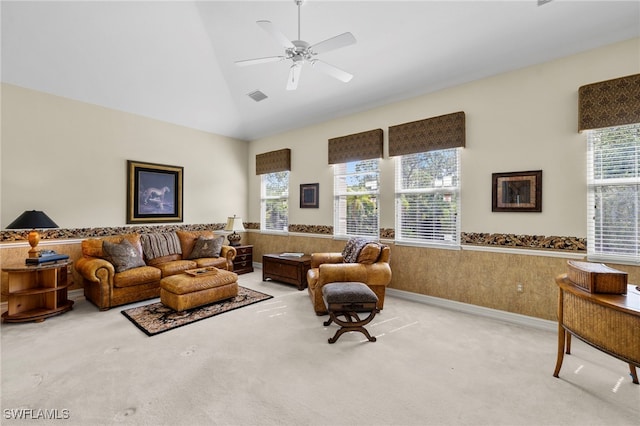 living area featuring visible vents, carpet flooring, high vaulted ceiling, and a ceiling fan