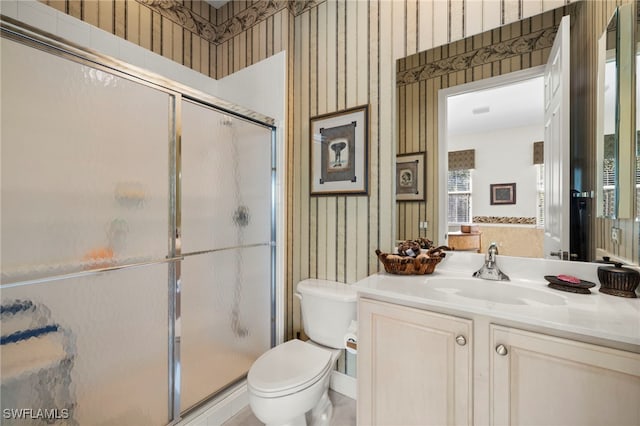 full bathroom with wallpapered walls, vanity, a shower stall, and toilet