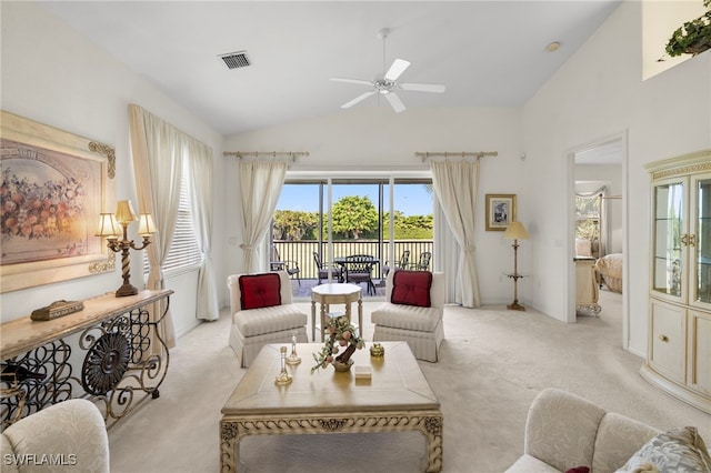 living area featuring vaulted ceiling, visible vents, a ceiling fan, and light carpet