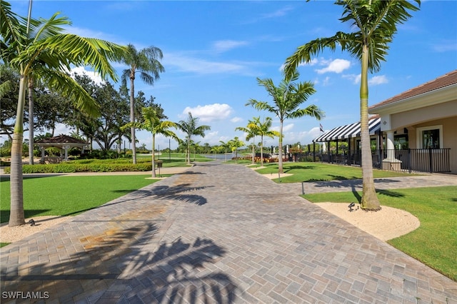 surrounding community with a lawn, a gazebo, and fence
