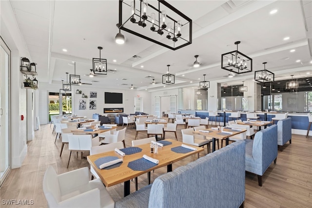 dining area featuring recessed lighting, an inviting chandelier, light wood-style floors, and a wealth of natural light