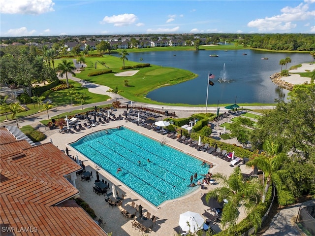 view of swimming pool featuring view of golf course and a water view