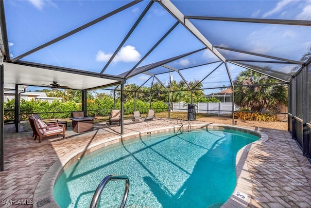 outdoor pool with a lanai, a patio, and fence