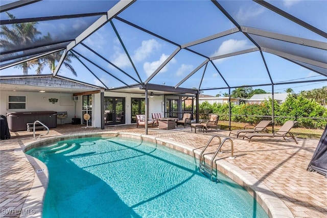 pool with an outdoor living space, a hot tub, a ceiling fan, a patio area, and a lanai
