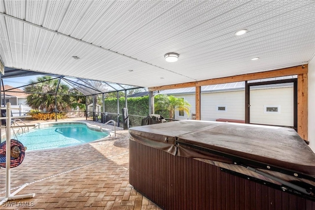 outdoor pool with a patio, a lanai, and a hot tub
