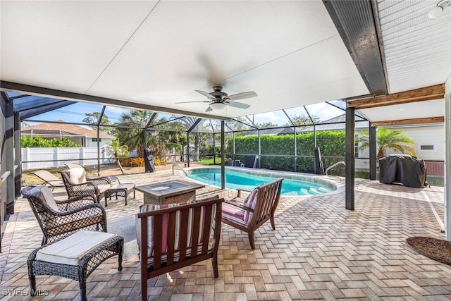 view of pool with an outdoor hangout area, a ceiling fan, glass enclosure, a patio, and a fenced in pool