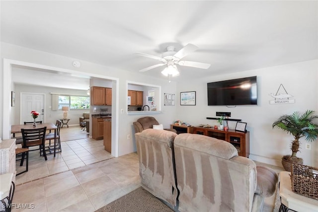 living room with light tile patterned floors and a ceiling fan