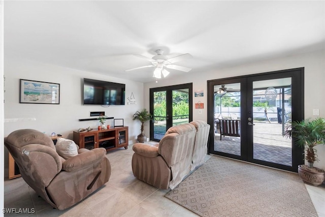 living room with french doors, ceiling fan, and light tile patterned flooring