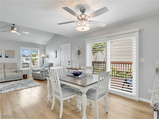 21687/689 Indian Bayou Dr, Fort Myers Beach, FL 33931 - dining room with ceiling fan, vaulted ceiling, plenty of natural light, and light wood-style floors