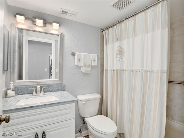 21687/689 Indian Bayou Dr, Fort Myers Beach, FL 33931 - full bath with a textured wall, toilet, and vanity