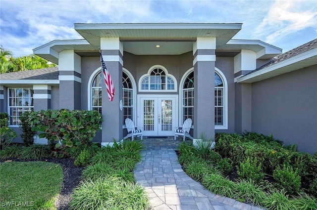 doorway to property featuring stucco siding and french doors