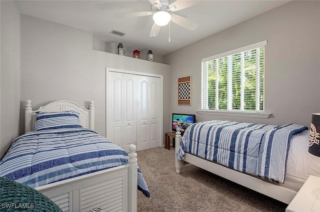 carpeted bedroom with a ceiling fan, a closet, and visible vents