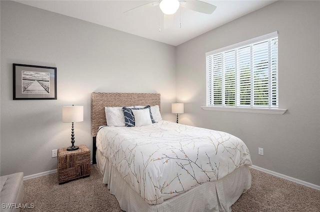 carpeted bedroom with a ceiling fan and baseboards