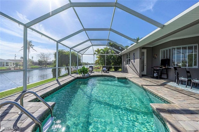 pool featuring glass enclosure, a water view, and a patio area