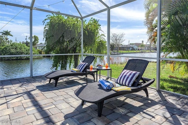unfurnished sunroom featuring a water view