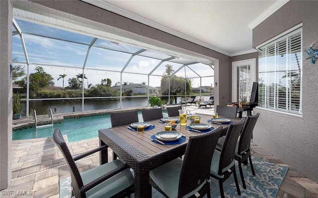 view of patio / terrace with a water view, a lanai, and an outdoor pool