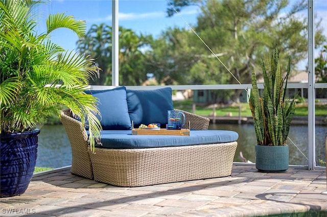view of patio with outdoor lounge area and a water view