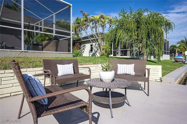 view of patio featuring glass enclosure and an outdoor hangout area