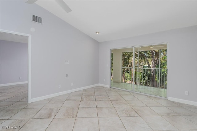 unfurnished room featuring baseboards, lofted ceiling, visible vents, and light tile patterned floors