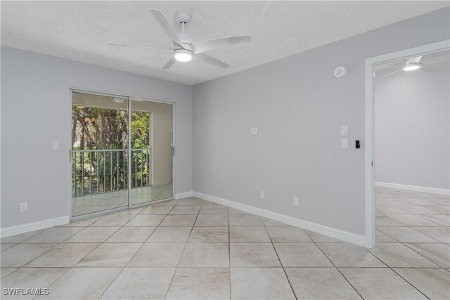 spare room with light tile patterned flooring, ceiling fan, and baseboards