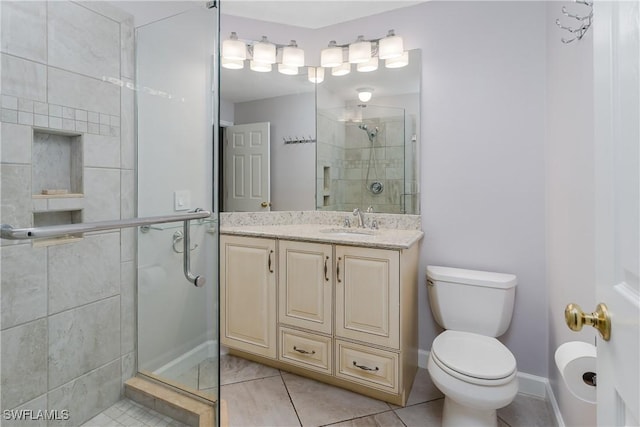 full bath with tile patterned flooring, vanity, toilet, baseboards, and a shower stall