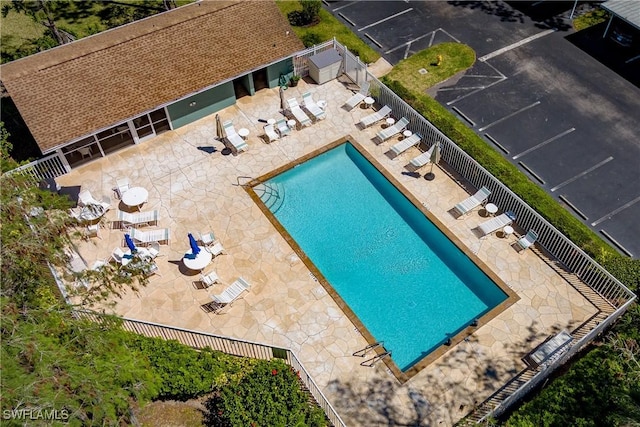 community pool featuring fence and a patio area