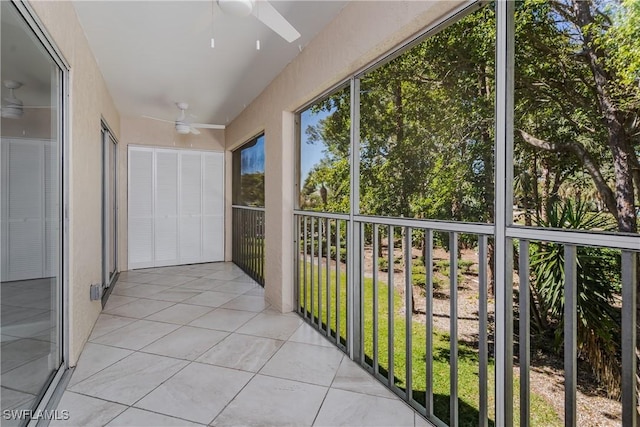 unfurnished sunroom featuring a ceiling fan