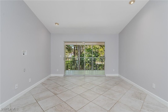 unfurnished room with baseboards and light tile patterned floors