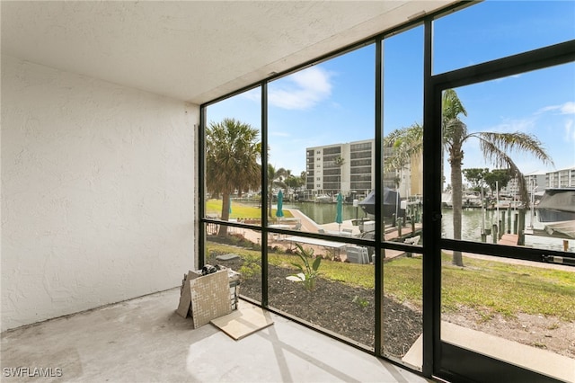unfurnished sunroom with a water view