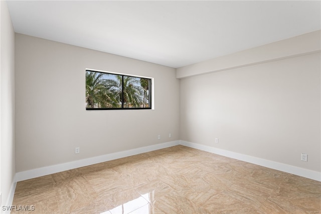 empty room featuring baseboards