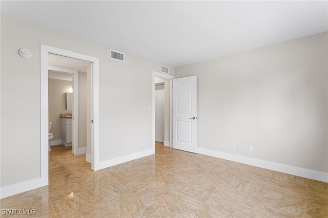 unfurnished bedroom featuring baseboards and visible vents