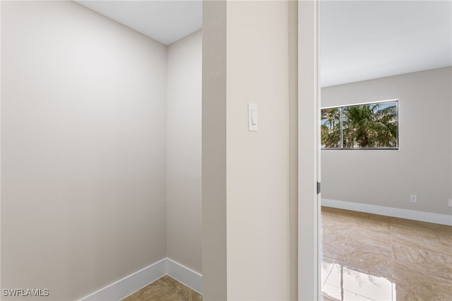 spare room with baseboards