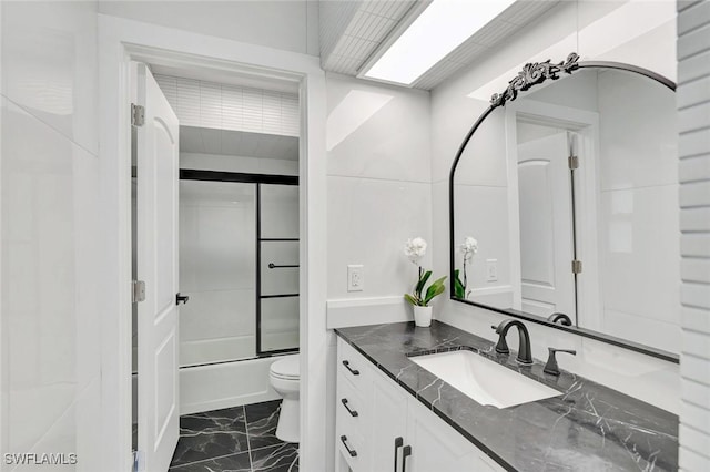 4500 1st Ave NW, Naples, FL 34119 - full bathroom featuring shower / bath combination with glass door, vanity, marble finish floor, and toilet