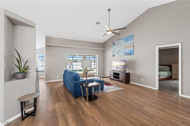 1703 SW 6th Ave, Cape Coral, FL 33991 - living area featuring a ceiling fan, high vaulted ceiling, wood finished floors, and baseboards
