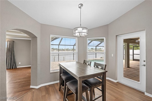 1703 SW 6th Ave, Cape Coral, FL 33991 - dining area with wood finished floors, arched walkways, healthy amount of natural light, and lofted ceiling